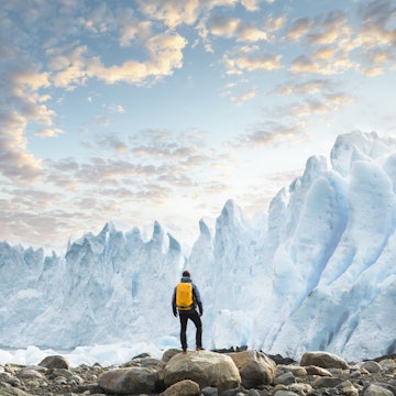 Hiker admiring the Perito Moreno glacier at sunset, Argentina